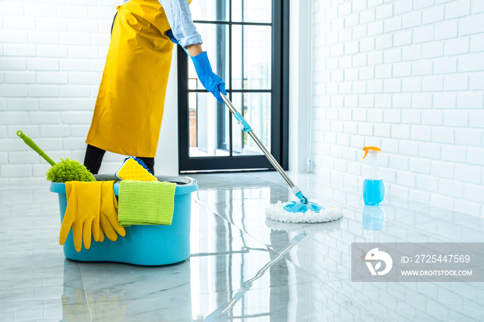 Wife housekeeping and cleaning concept, Happy young woman in blue rubber gloves wiping dust using mo