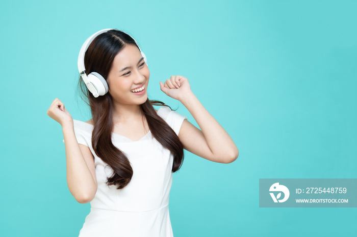 Young Asian beauty woman listening music with headphones in playlist song application on smartphone 