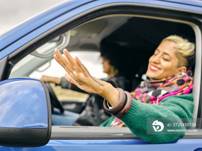 Smiling woman leaning out of car window