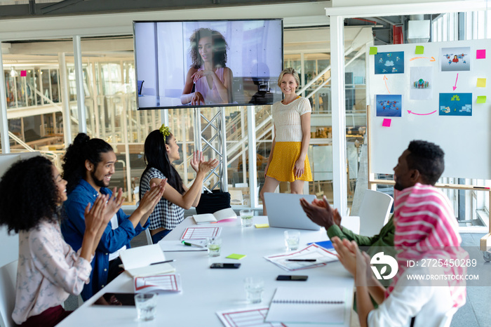 Business people applauding during video conference at conference room in a modern office