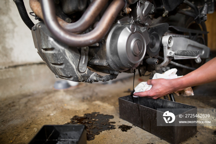 Motorbike and running oil from the engine, changing oil, regular maintenance