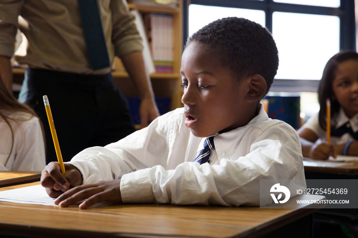 Students writing in classroom