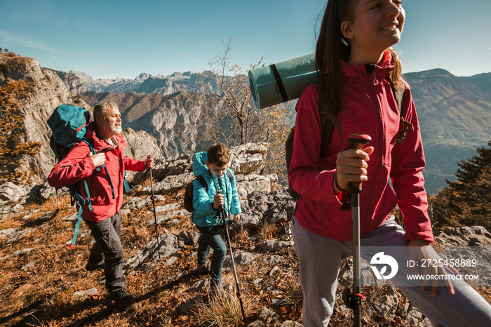 Father with two kids hiking in mountains