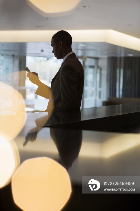 Businessman using smart phone in modern office