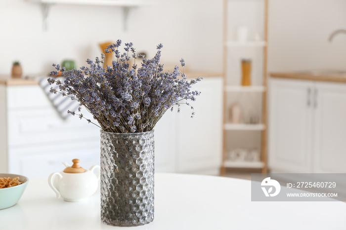 Vase with beautiful lavender flowers in kitchen