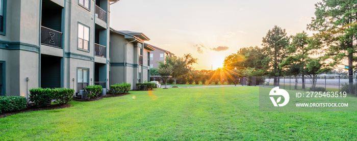 View from grassy backyard of a typical apartment complex building in suburban area at Humble, Texas,