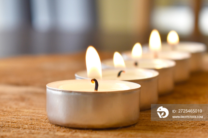 Tea light candle on wood.