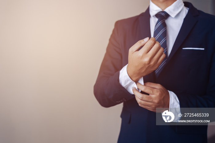 businessman wearing business suit fasten cufflink or button on sleeve of classic jacket and factory 