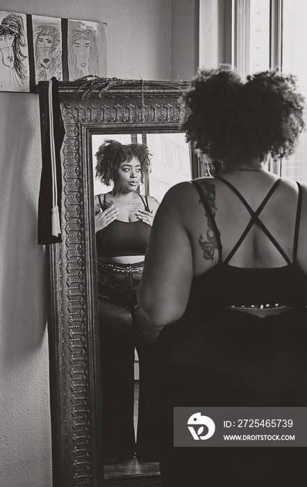 Black woman admiring herself in the mirror