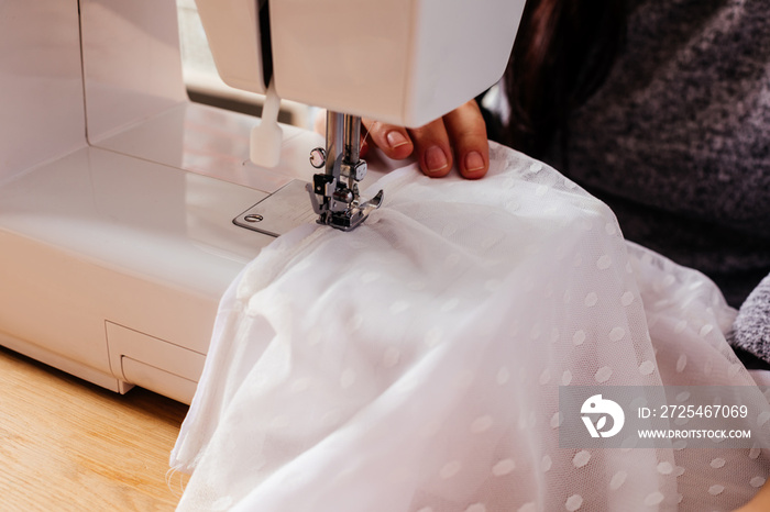 Wedding dressmaker altering white vintage wedding dress