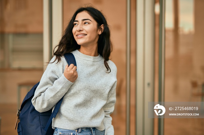 Young middle east student girl smiling happy standing at the city.