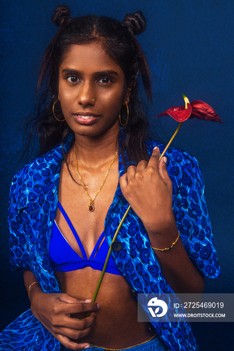 portrait of dark skinned Indian woman from Malaysia against dark blue background