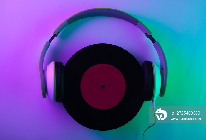 Stereo headphones with a vinyl record. Neon, holographic light. gradient violet-green glow. Retro wa