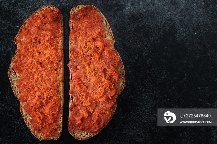 Two slices of mallorcan bread with meat spread “Sobrasada” typical of Majorca.  Close-up top view on