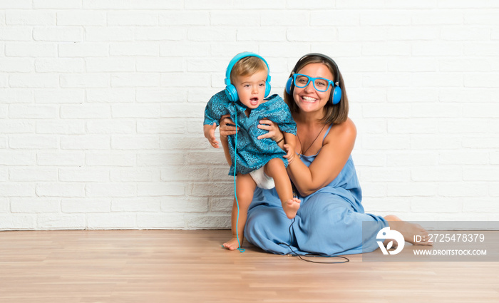 Adorable little baby with his mother listening music