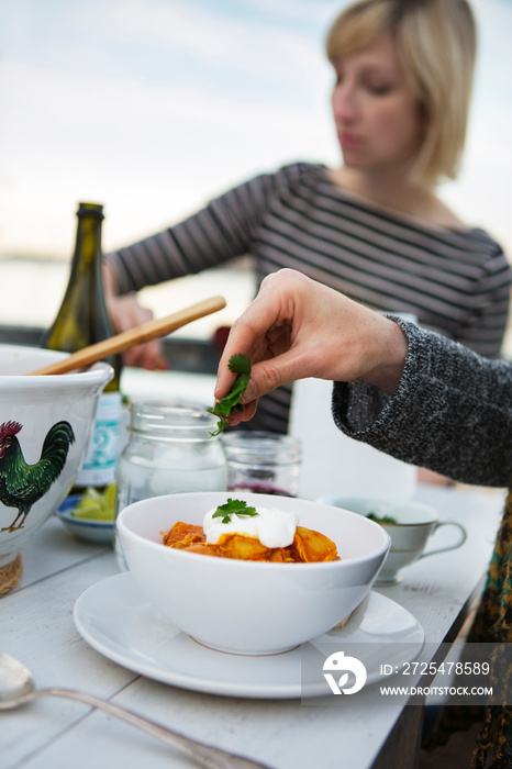 Mid adult woman eating dinner