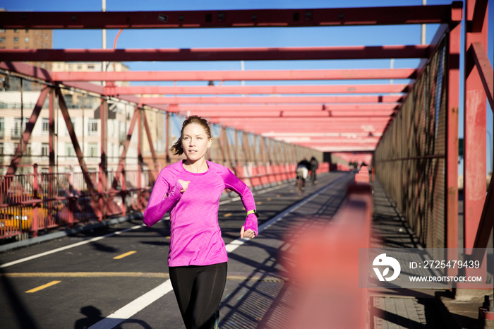 Woman running on footbridge