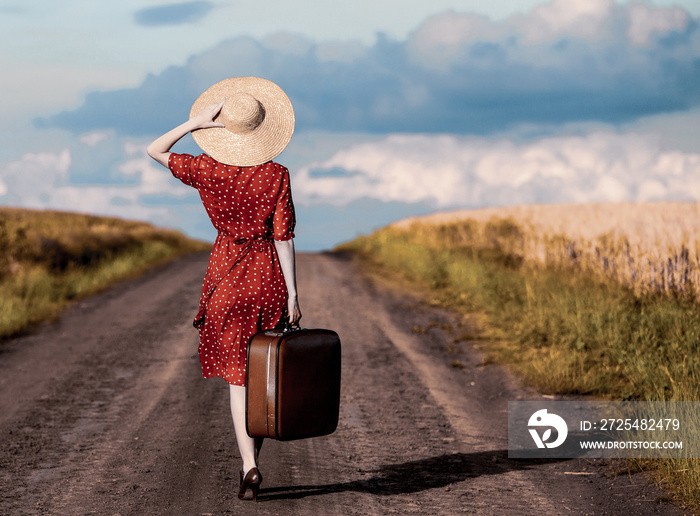 Redhead girl with suitcase at outdoor.