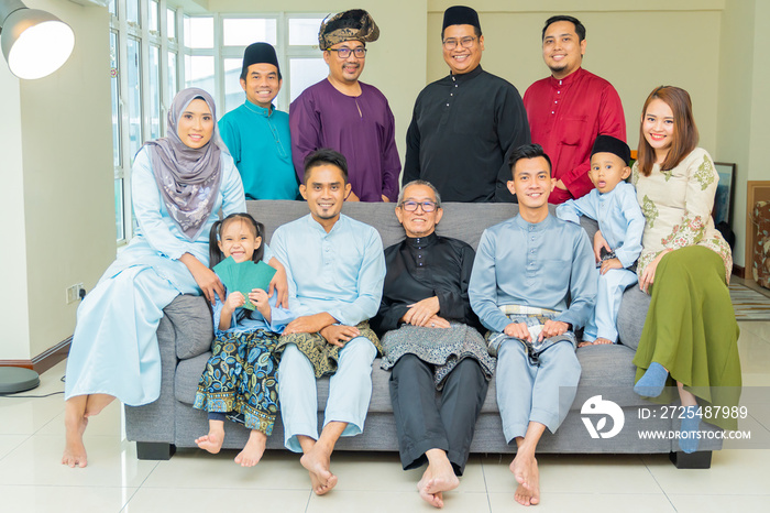 Eid Mubarak celebration moment, family photo at the sofa wearing traditional cloth