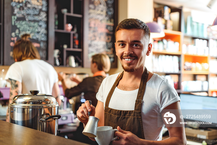 cheerful bartender smiling in a cafe