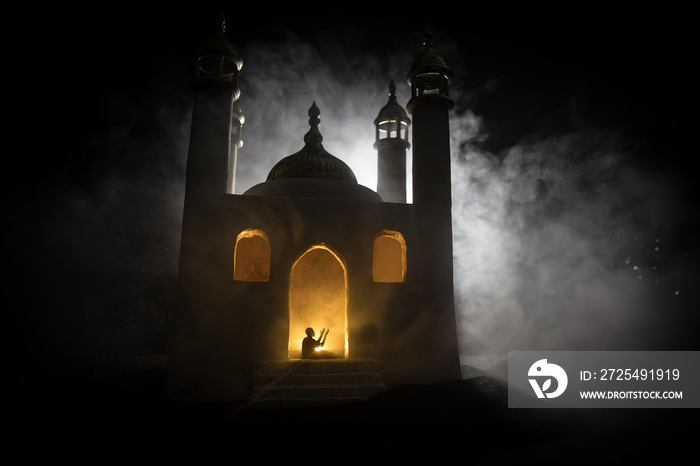 Silhouette of mosque building on toned foggy background. Ramadan Kareem background. Mosque at sunset