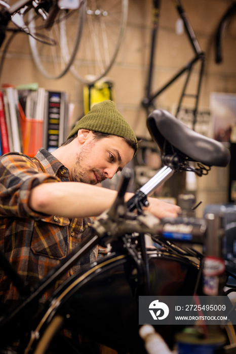 Mid-adult man repairing bicycle