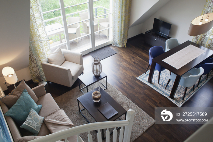 High angle view of open plan dining area and living room in contemporary house