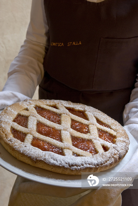 Waiter holding a pie