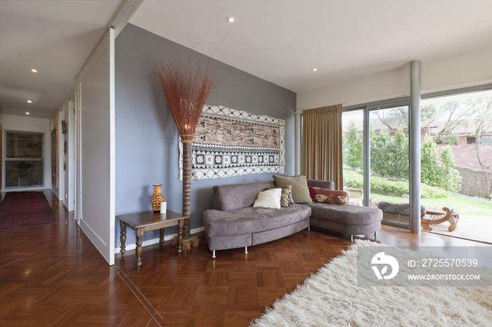 Sofa and cushions in living room of contemporary house