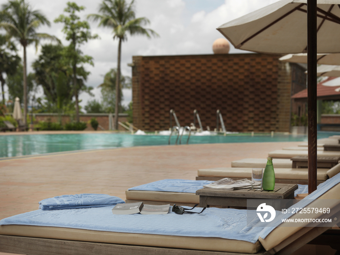 Lounge chairs at poolside of resort