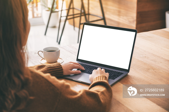 Mockup image of a woman using and typing on laptop computer keyboard with blank white desktop screen