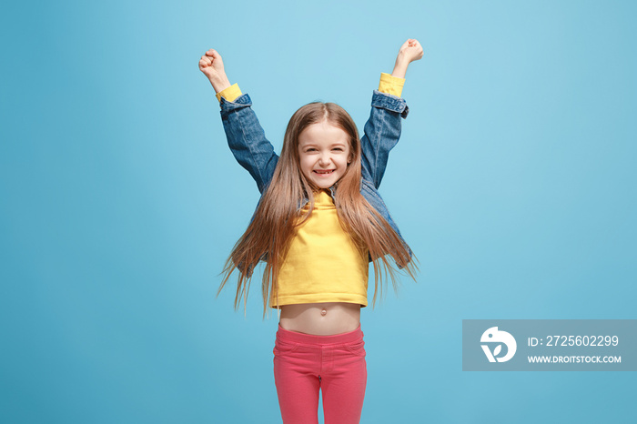 Happy success teen girl celebrating being a winner. Dynamic energetic image of female model