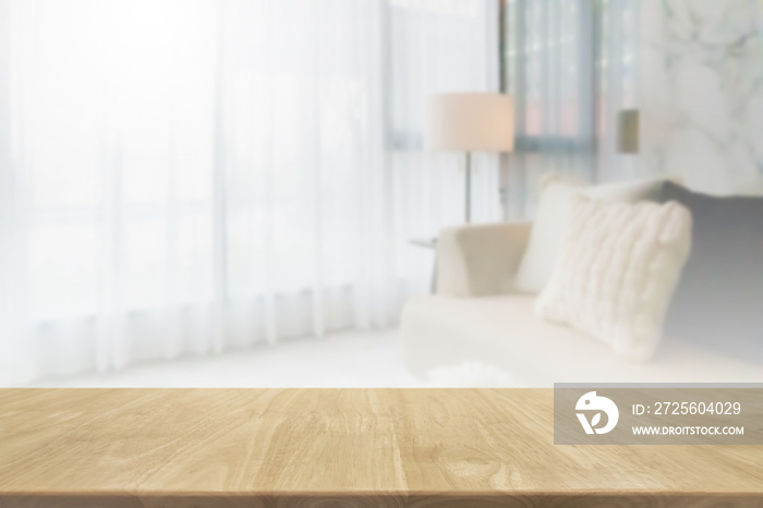 Empty wood table top and blurred living room in home interior with curtain window background. - can 