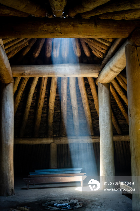 Light streams through smoke from a fire pit in a Mandan Indian house at Fort Lincoln near Bismarck, 