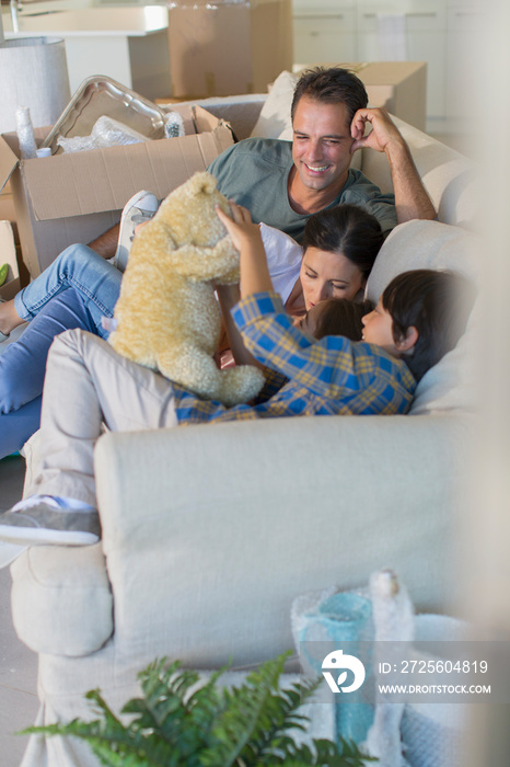 Family on sofa taking a break from unpacking in new house