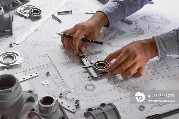 Engineer technician designing drawings mechanical parts engineering Engine.manufacturing factory Ind