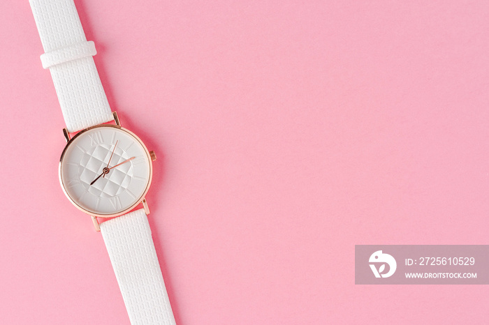 Women’s watch on pink background