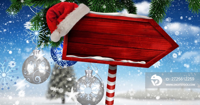 Digital composite image of santa hat on blank red direction sign board with copy space during winter