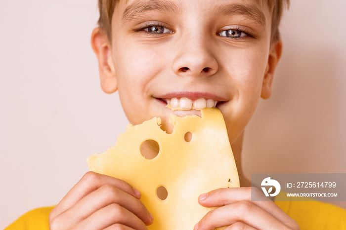 Boy biting a piece of cheese portrait close-up