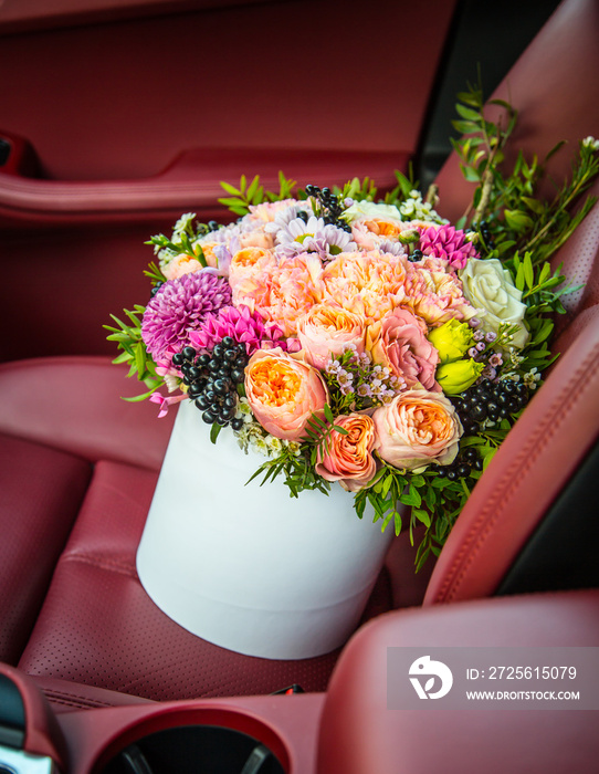 Bouquet of flowers roses luxury gift box in the car seat