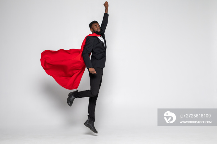 Young african businessman jump for flight hero with fist up isolated on white background