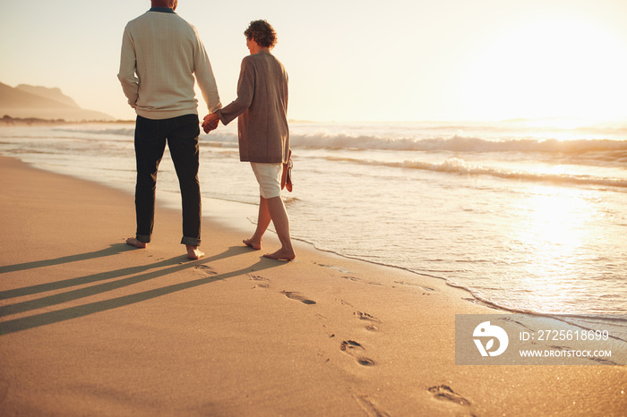 Senior couple walking along the sea shore