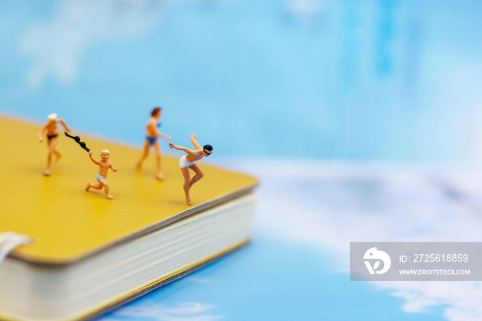 Miniature people: Tourists Sunbathing on the beach. Concept of traveling, business concept.