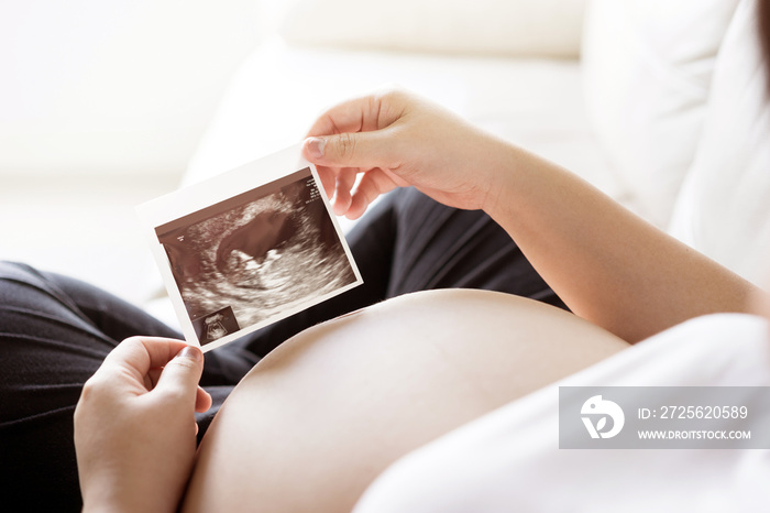 Pregnant woman with ultrasound scan picture