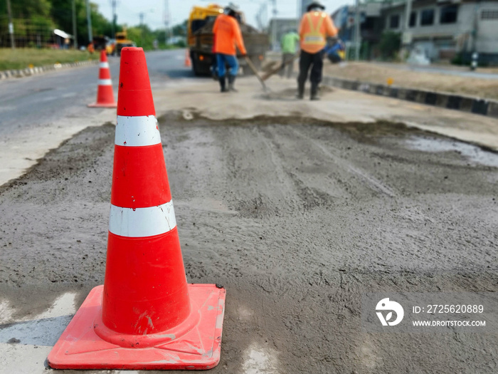 Motion blur, road construction with a red rubber cone in front