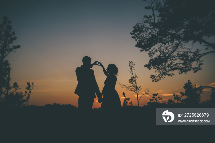 loving couple in silhouette on the sunset