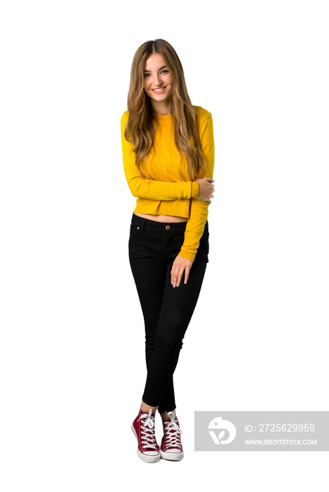 A full-length shot of a young girl with yellow sweater With happy expression on isolated white backg