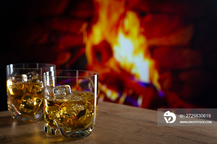 Glass of whiskey in front of a fireplace