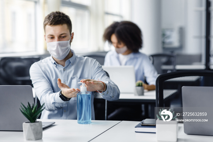 Rules for safety health during coronavirus outbreak. Man in protective mask treat his hands with ant