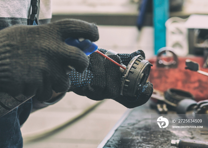 The mechanic fixing  one of working car parts